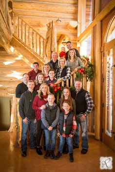 a group of people standing in front of a christmas tree