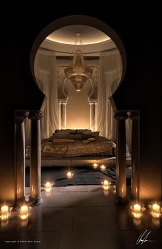 candles are lit in front of a bed with white drapes on the walls and ceiling