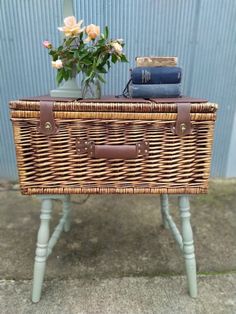 a wicker table with a basket and flowers on top