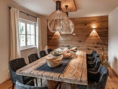 a wooden table with chairs around it and a bowl on the table next to it