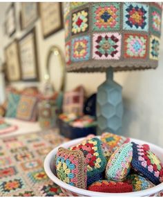 a bowl filled with crocheted granny's afghans on top of a table