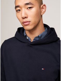 Tommy Hilfiger men's hoodie. Lean into timeless casual style with this hoodie made from soft, lightweight fleece, complete with a kanga pocket and subtle branding.  Material: 73% Cotton (rgc), 27% Recycled Polyester (rpe). Classic Hooded Sweatshirt With Ribbed Cuffs, Classic Long Sleeve Hoodie With Drawstring, Classic Hoodie Sweatshirt With Ribbed Cuffs, Classic Cotton Sweatshirt With Drawstring Hood, Classic Hooded Sweatshirt With Drawstring, Classic Cotton Hoodie With Drawstring Hood, Winter Essential Hooded Hoodie, Essential Winter Hooded Hoodie, Essential Cotton Hoodie For Winter