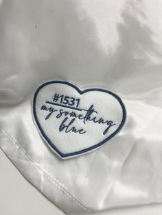 a white jacket with a blue heart and the words, i love my grandmother on it