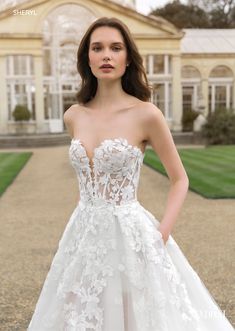 a woman in a wedding dress standing outside