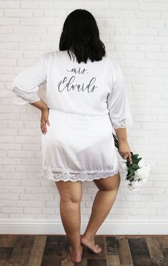 "Plus Size Personalized Bride Robes with her future last name name printed in a pretty script make a cute gift for the bride to be to wear on her wedding morning - perfect getting ready robes for your bridal party on your wedding day! Our delicate lace trimmed robes come with her name on the back in your choice of gold foil, rose gold foil, silver foil, or black text. Each soft satin robe comes with a matching belt. Details Listing is for 1 PLUS SIZE Lace Trimmed Robe - with name printed on back Bride Robe Personalized, Personalized Bride Robe, Cute Bridal Shower Gifts, Bride Robes, Getting Ready Robes, Bridal Robe Lace, Bridesmaid Robe Personalized, Plus Size Satin, Plus Size Bride