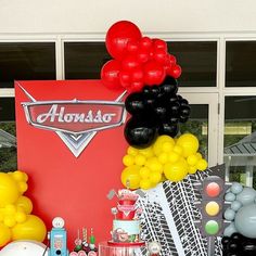 an assortment of balloons and other items on display in front of a sign that says autosport