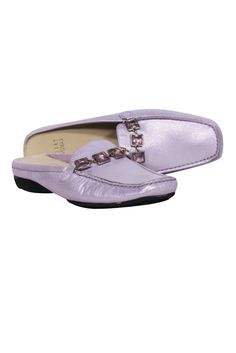 Add a feminine feel to your work wardrobe with these lovely lavender mule loafers from Stuart Weitzman. With a shimmering metallic sheen and stunning crystal rhinestones, you'll be sparkling with every step you take. Instantly elevate your office style with these luxe leather shoes. Size 7 Leather Slip-on Square toe Crystal embellishment Light wear at heels Small spot by right heel Toe to heel 9.5" Heel .75" Spring Formal Flats With Rhinestones, Elegant Synthetic Spring Loafers, Elegant Synthetic Loafers For Spring, Elegant Formal Summer Slip-ons, Elegant Formal Purple Loafers, Elegant Purple Formal Loafers, Purple Mules, Summer Purple Mules, Flat Silver Leather Mules