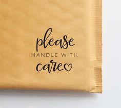 a piece of brown paper with the words please handle with care written on it and black ink