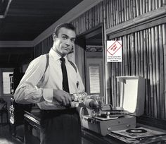 a man standing in front of a typewriter