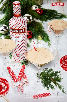 two martinis with candy canes on the table