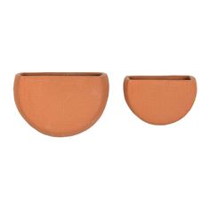 two brown vases sitting next to each other on a white background, one is shaped like a half circle