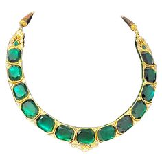 This gorgeous, one-of-a-kind Polki necklace is absolutely stunning. The bold color and size of the rich green glass stones really makes a statement, while the natural diamonds add an extra touch of sparkle. This incredible necklace features 13 square cut cornered green glass stones bezel set in 18 karat yellow gold and arranged in a single elegant line. At the center and ends of the piece, as well as in between each green stone, are small accents of uncut diamonds (H-J / SI1) totaling 4.25 carat Green Emerald Kundan Necklace With Gemstones, Green Jeweled Kundan Necklace For Formal Occasions, Green Kundan Necklace With Jewels For Formal Occasions, Formal Green Kundan Necklace With Jewels, Luxury Green Emerald Necklace With Stones, Luxury Green Stone Necklaces, Luxury Faceted Green Necklace, Luxury Green Faceted Necklaces, Luxury Green Faceted Necklace