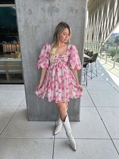 Romantic and dainty! Our Emery Mini Dress is a red, floral print, babydoll style, mini dress with big puff sleeves, ruffle detail neckline, and a hidden zipper! Throw on a pair of lace up heels to dress her up for any occasion! Style Recommendations: - Pair a heel to dress her up for a wedding! - Add an under the knee boot for a trendy, edgy, look! Product Description and Materials: - Red floral mini dress - Straight neckline, ruffle detail - Puff sleeve - Baby doll style - Machine wash cold / d Spring Mini Dress With Puff Sleeves And Gathered Neckline, Feminine Puff Sleeve Mini Dress With Gathered Neckline, Flirty Puff Sleeve Dress With Smocked Bodice For Spring, Flirty Spring Puff Sleeve Dress With Smocked Bodice, Cute Pink Puff Sleeve Dress With Floral Print, Flirty Puff Sleeve Mini Dress With Floral Print, Spring Puff Sleeve Mini Dress With Gathered Neckline, Spring Mini Puff Sleeve Dress With Gathered Neckline, Flirty Mini Puff Sleeve Dress With Floral Print