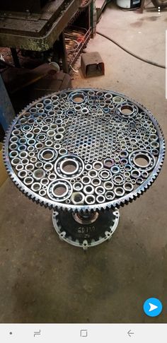 an image of a metal table with circles on the top and holes in the middle