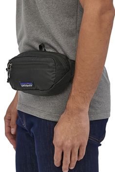 Great for any adventure, this Patagonia Ultralight Mini Hip Pack in Black has got us wanting to go on more adventures. There is a main zipper compartment to carry all your essentials needs and turns inside out for easy storage. Going on a hike has never been easier!Features of Patagonia Ultralight Mini Hip Pack in Black | 49447-BLK:PatagoniaStyle: 49447-BLKColor: Black100% Recycled NylonPatagonia hip packTurns inside for easy storageAdjustable clipTop zipperSide zipperPadded back for hip comfortPatagonia logo patch on front Patagonia Country, Patagonia Style, Patagonia Logo, Hip Pack, Black Holes, Webbing Belt, Hip Bag, Water Resistant Fabric, Helly Hansen