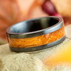 a wedding band that has been made to look like an orange wood in the center