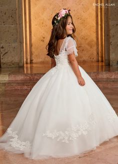 Your sweet girl will captivate the room in this long applique short sleeve dress with A-line skirt by Rachel Allan RB9145. Walk down the aisle in true elegance wearing Rachel Allan's beautiful tulle ballgown. This gorgeous gown is a beautiful sight to behold, with applique and beading details throughout. The sheer flowing sleeves will make any flower girl feel like a princess, and the lace-up back adds a unique touch. Perfect for any special occasion, this stunning dress will make her feel like Lace Dress For First Communion With Short Sleeves, Fitted Tulle Gown For Confirmation, Short Sleeve Lace Confirmation Dress, Short Sleeve Lace Dress For Confirmation, Ball Gown Dresses With Lace Sleeves And Fitted Bodice, White Lace First Communion Dress For Debutante Ball, White Short Sleeve First Communion Dress For Pageant, White First Communion Dress With Lace Bodice, Fitted First Communion Dress With Short Sleeves