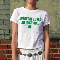 Everyone Loves An Irish Girl Baby Tee, Women's Fitted Tee, Y2K Slogan Tee, Trendy Top, Funny Shirt, Funny Sayings, 90s Style Tee DETAILS - 100% cotton (fiber content may vary for different colors) - tear-away label  SIZING Sizes vary by shirt style. Please check the size chart before making your purchase. PLEASE NOTE: Our Baby tee is sized for a youth, reminiscent of the '90s-era shrunken-down T-shirt. This style, popularized by the skater/raver culture of the time, is not to be confused with th Y2k Green Tops With Screen Print, Y2k Style Green Tops With Screen Print, 90s Green Tops With Letter Print, 90s Green Letter Print Tops, Green Cotton Band Merch Top, 90s Style Green Screen Print Top, Fitted Funny Print Band Merch Tops, Cute Green Top With Slogan, Y2k Slogan