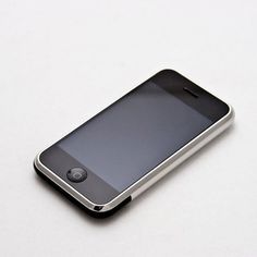 an iphone sitting on top of a white table