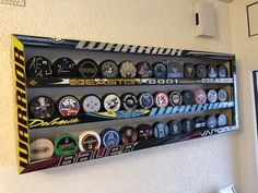 a display case filled with lots of different types of sports memorabilia on a white wall