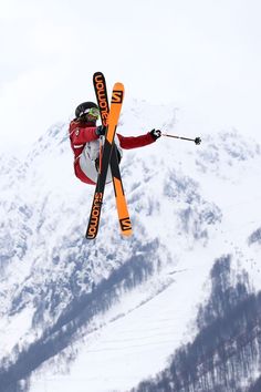 a man flying through the air while riding skis