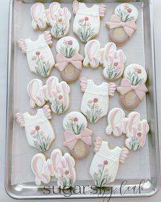 decorated cookies in the shape of baby clothes