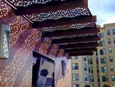 an outdoor covered area with several buildings in the background