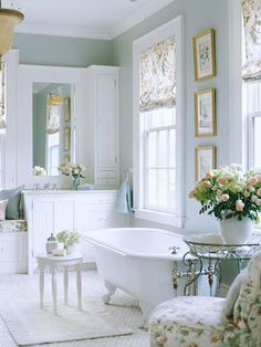 an image of a white bathroom with flowers in the tub