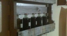 six bottles are in a wooden box on the wall