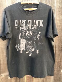 Chase Atlantic Unisex Tshirt, Chase Atlantic Graphic Shirt, Vintage Chase Atlantic Concert Tour 2024 Shirt, Fans Gift All t-shirts are custom made to order and are printed using the latest ink to garment technology, a technology superior to heat transfer or screen print. - Heather colors are 52% combed and ring-spun cotton, 48% polyester - Athletic and Black Heather are 90% combed and ring-spun cotton, 10% polyester - Solid Colors 100% pre-shrunk cotton - Fiber content may vary by color FOR THE Chase Atlantic Tshirt, Band Merch Crew Neck T-shirt, Band Merch Tops With Screen Print For Fans, Unisex Band Logo T-shirt Crew Neck, Band Logo Crew Neck T-shirt, Band Logo T-shirt With Crew Neck, Unisex Graphic Print Shirt For Fan Merchandise, Band Logo T-shirt For Music Festivals, Pre-shrunk Crew Neck Grunge Shirt