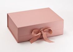 a pink box with a bow on the side