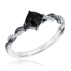 a black diamond ring with white diamonds on the sides and an oval shaped stone in the center