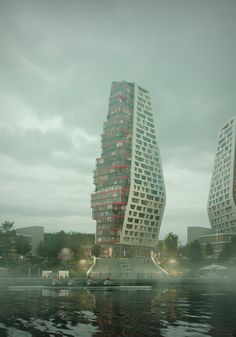 two tall buildings sitting next to each other on top of a body of water in front of a cloudy sky