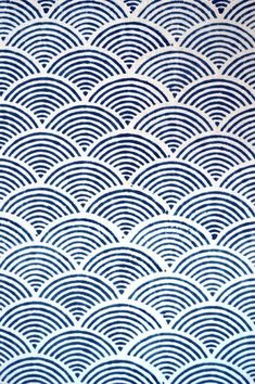 a blue and white wallpaper with wavy waves in the shape of an ocean wave