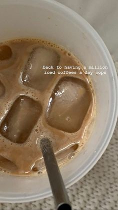 a cup of coffee with ice cubes in it