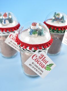 three snow globes with christmas decorations in them