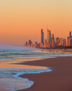 the city skyline as seen from the beach at sunset