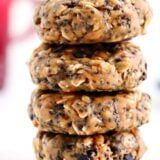 three cookies stacked on top of each other with chocolate chips in the middle and oats scattered around them