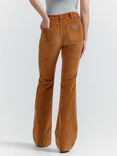 Your favorite flare is back, but now in the perfect texture for the season ahead. Our Women’s Wrangler Retro® Bailey High Rise Corduroy Trouser Jean comes with all the same iconic details, including our signature five-pocket styling, the “W” stitching, and a logo patch. That ultra-soft corduroy is crafted from a cozy cotton blend with just the perfect amount of stretch. Best of all, these trousers feature a flattering high-rise silhouette that hugs you in all the right places. Wrangler Corduroy Pants, Trouser Jeans Outfit Western, Corduroy Flare Pants Outfit, Fall Flare Jeans, Trouser Jeans Outfit, Corduroy Pants Outfit, Western Pants, Corduroy Flare Pants, Wrangler Pants