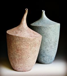 two vases sitting next to each other on a table