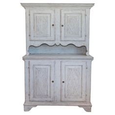 an old white cabinet with two doors and drawers on the top, against a white background