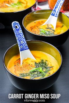 three bowls filled with soup on top of a black table next to other food items