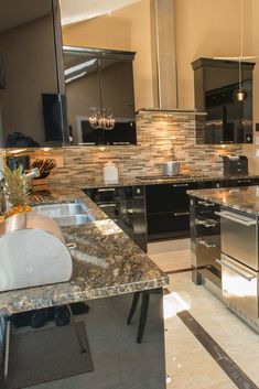 a kitchen with marble counter tops and stainless steel appliances