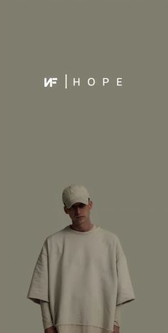 a man standing in front of a grey background with the words hope on it's side