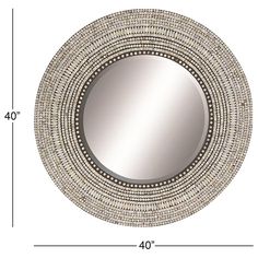 a round mirror with beading around the edges and an area for measurements to be displayed