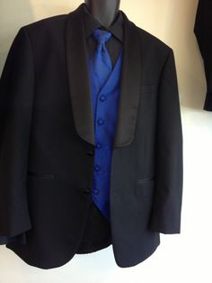 a black suit with blue shirt and tie