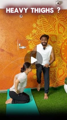 a man and woman doing yoga in front of an orange wall with the words heavy thighs?