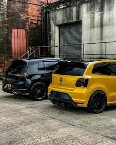 two cars parked next to each other in front of a building