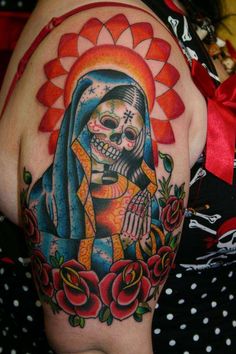 a woman's arm with a tattoo on it, and a skeleton in the middle