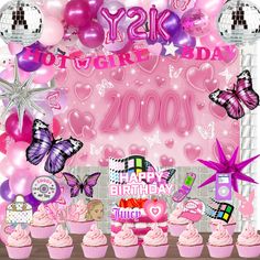 a pink birthday party with balloons and cupcakes